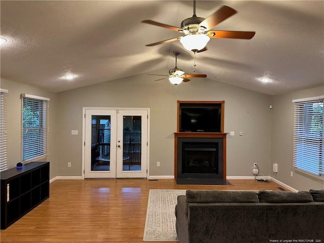 6622 Vaughn Rd, Fayetteville, NC 28304 - living area with wood finished floors, a ceiling fan, lofted ceiling, french doors, and a fireplace