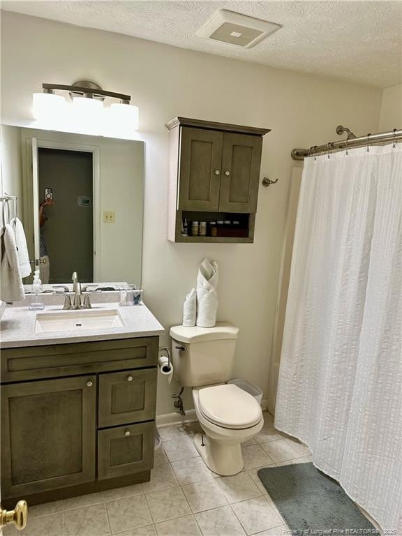 6622 Vaughn Rd, Fayetteville, NC 28304 - full bath featuring vanity, tile patterned flooring, a textured ceiling, and a shower with shower curtain