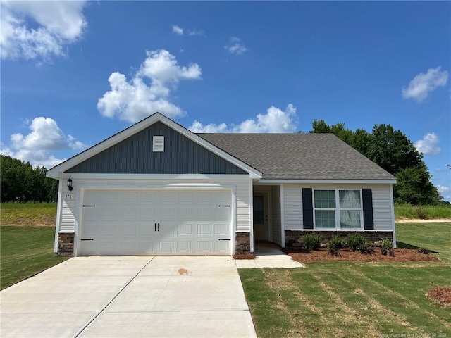 376 Chedworth Dr, Angier, NC 27501 - view of front of property featuring stone siding, driveway, a front yard, and an attached garage