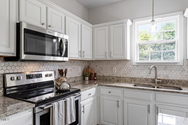 1643 Southcross St, Fuquay Varina, NC 27526 - kitchen featuring stainless steel appliances, white cabinetry, backsplash, and light stone counters