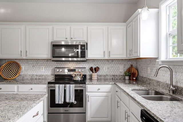 1643 Southcross St, Fuquay Varina, NC 27526 - kitchen with appliances with stainless steel finishes, white cabinetry, plenty of natural light, and decorative backsplash