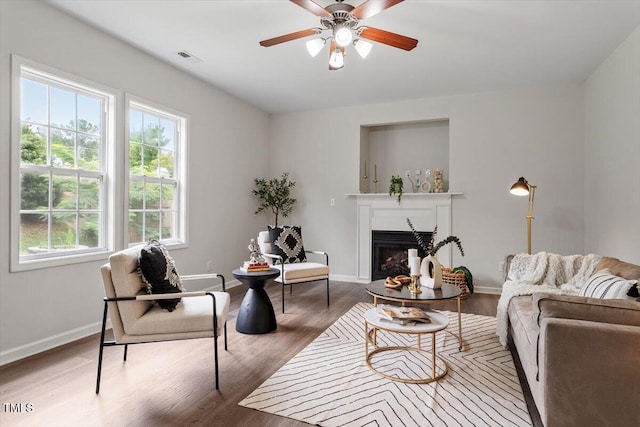 1643 Southcross St, Fuquay Varina, NC 27526 - living area featuring a fireplace, a ceiling fan, and wood finished floors
