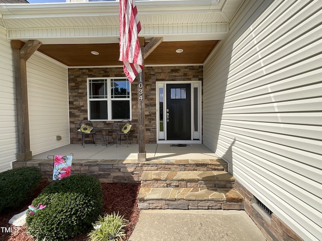 1034 Snapdragon Dr, Wake Forest, NC 27587 - entrance to property with a porch and stone siding