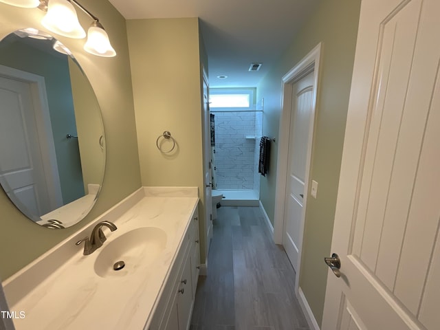 1034 Snapdragon Dr, Wake Forest, NC 27587 - full bathroom featuring vanity, a shower, and wood finished floors