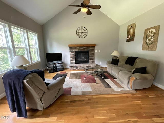 1034 Snapdragon Dr, Wake Forest, NC 27587 - living area featuring a stone fireplace, a ceiling fan, wood finished floors, and high vaulted ceiling