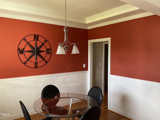 1034 Snapdragon Dr, Wake Forest, NC 27587 - dining area featuring wainscoting, wood finished floors, and ornamental molding