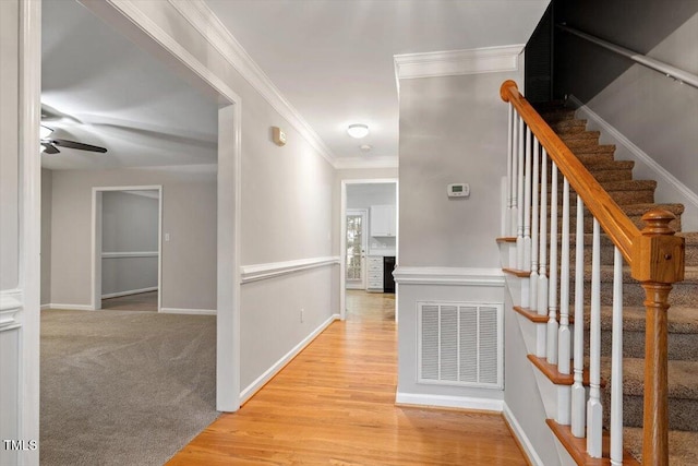 903 Norood Ln, Apex, NC 27502 - hallway with ornamental molding, light wood-type flooring, and stairway