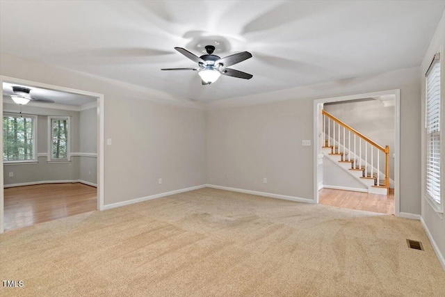 903 Norood Ln, Apex, NC 27502 - empty room with carpet, ceiling fan, and stairway