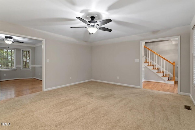 903 Norood Ln, Apex, NC 27502 - spare room featuring carpet floors, ceiling fan, and stairway
