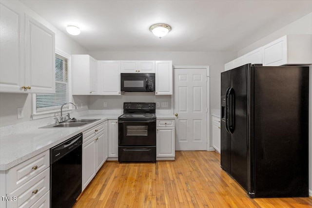 903 Norood Ln, Apex, NC 27502 - kitchen with black appliances, white cabinets, and light wood-type flooring