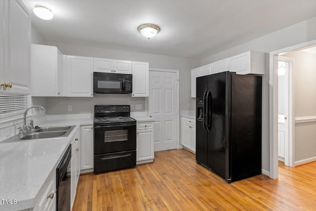 903 Norood Ln, Apex, NC 27502 - kitchen featuring black appliances, white cabinets, and light wood finished floors