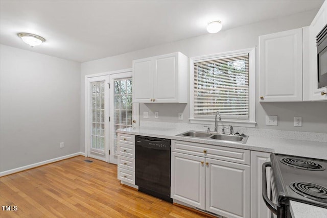 903 Norood Ln, Apex, NC 27502 - kitchen featuring dishwasher, range with electric cooktop, light countertops, white cabinetry, and healthy amount of natural light