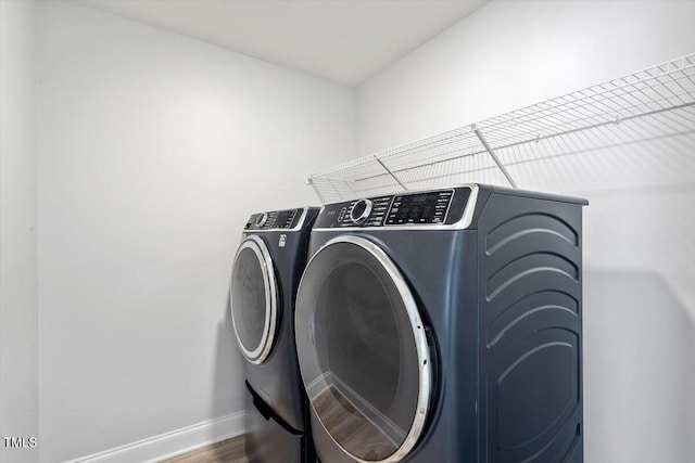 815 Harmony Ranch Ln, Franklinton, NC 27525 - laundry area featuring washer and dryer and wood finished floors