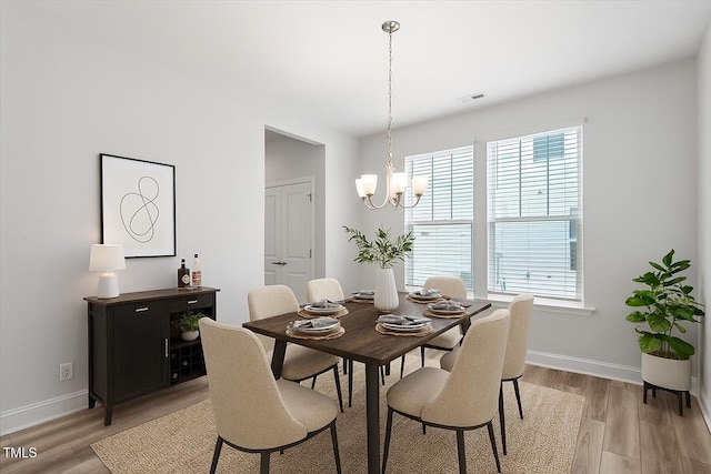 815 Harmony Ranch Ln, Franklinton, NC 27525 - dining space with light wood-style floors and a chandelier