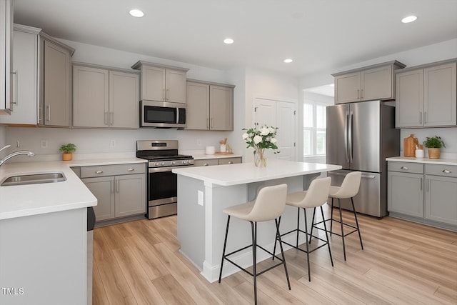 815 Harmony Ranch Ln, Franklinton, NC 27525 - kitchen featuring stainless steel appliances, gray cabinets, a breakfast bar, a center island, and recessed lighting