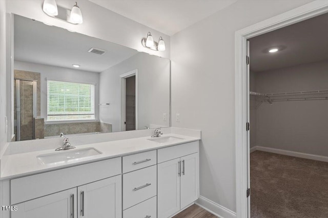 815 Harmony Ranch Ln, Franklinton, NC 27525 - full bath with double vanity, a stall shower, and a spacious closet
