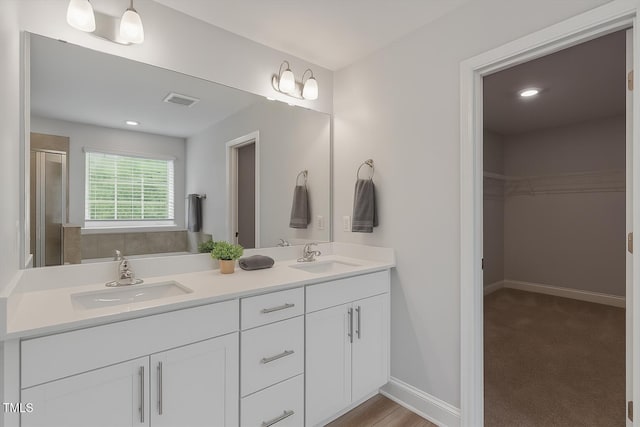 815 Harmony Ranch Ln, Franklinton, NC 27525 - full bath with double vanity, a walk in closet, and a stall shower
