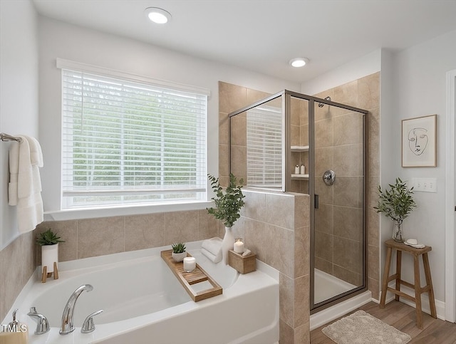 815 Harmony Ranch Ln, Franklinton, NC 27525 - bathroom featuring a bath, a stall shower, and wood finished floors