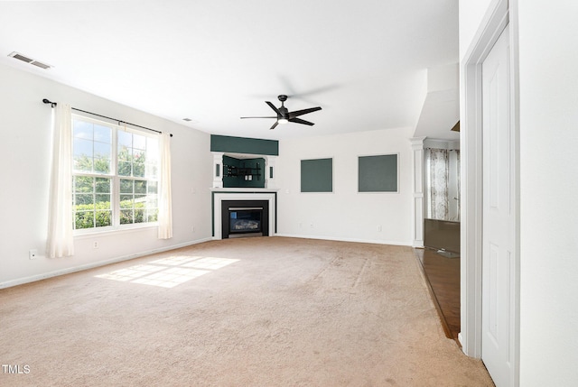 2486 Ingleside Dr, High Point, NC 27265 - unfurnished living room with ceiling fan, a glass covered fireplace, and carpet