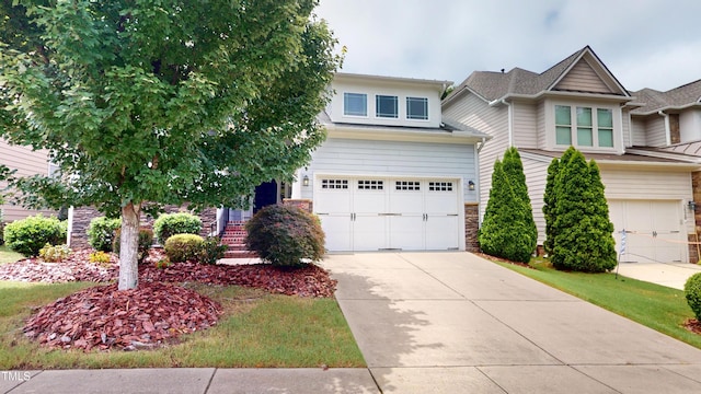 1524 Lily Creek Dr, Cary, NC 27518 - view of front facade with a garage, stone siding, and driveway