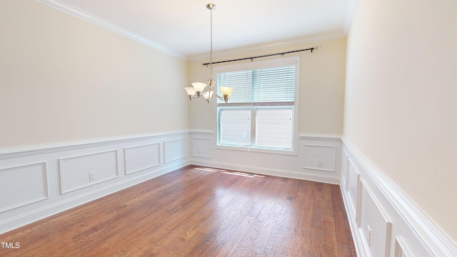 1524 Lily Creek Dr, Cary, NC 27518 - unfurnished room with a chandelier, a decorative wall, wood finished floors, ornamental molding, and a wainscoted wall