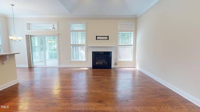1524 Lily Creek Dr, Cary, NC 27518 - unfurnished living room featuring a chandelier, a fireplace with flush hearth, crown molding, dark wood-style floors, and plenty of natural light