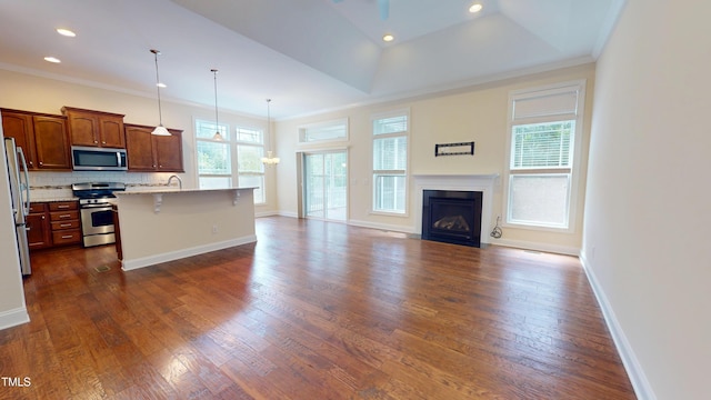 1524 Lily Creek Dr, Cary, NC 27518 - kitchen featuring open floor plan, stainless steel appliances, backsplash, a breakfast bar area, and dark wood finished floors