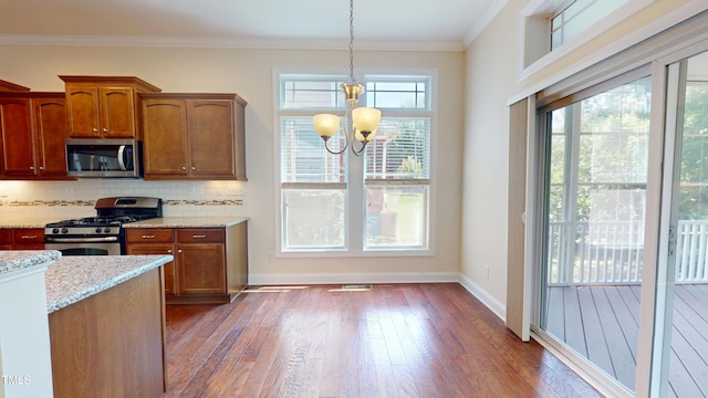 1524 Lily Creek Dr, Cary, NC 27518 - kitchen featuring a chandelier, appliances with stainless steel finishes, dark wood finished floors, tasteful backsplash, and crown molding