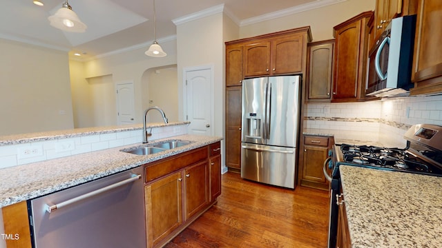 1524 Lily Creek Dr, Cary, NC 27518 - kitchen featuring appliances with stainless steel finishes, crown molding, dark wood-type flooring, hanging light fixtures, and decorative backsplash
