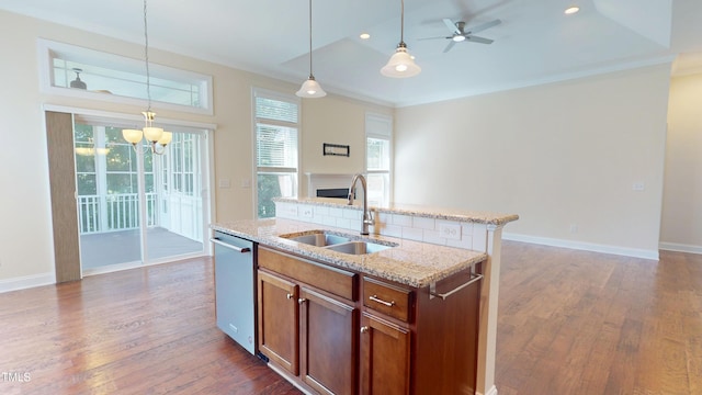 1524 Lily Creek Dr, Cary, NC 27518 - kitchen featuring dark wood-type flooring, hanging light fixtures, open floor plan, stainless steel dishwasher, and light stone counters