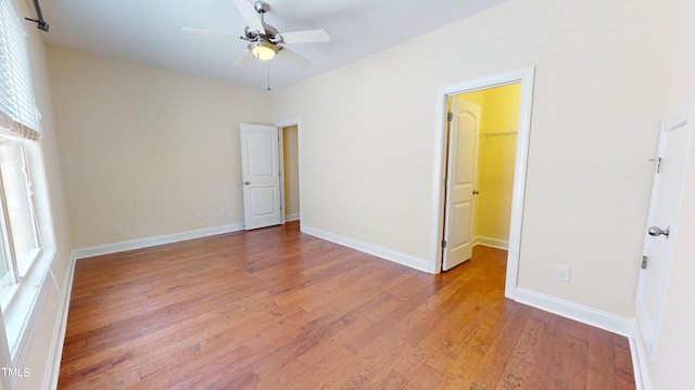 1524 Lily Creek Dr, Cary, NC 27518 - unfurnished bedroom with light wood-style flooring, a spacious closet, and ceiling fan