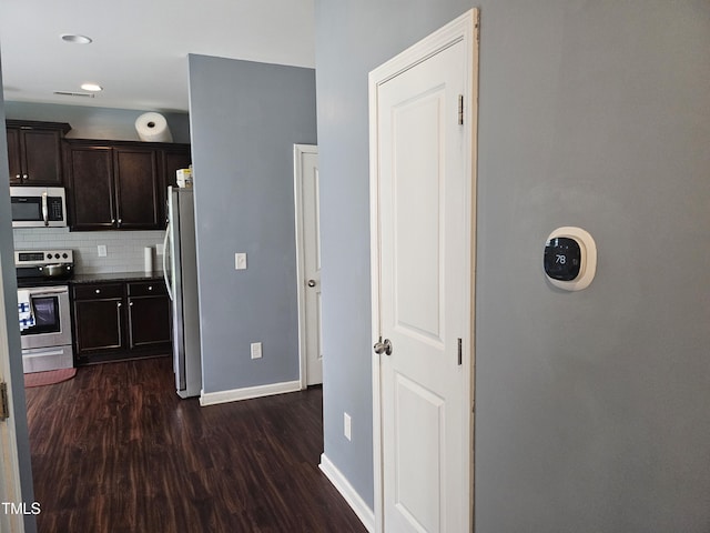 1303 Salters St, Burlington, NC 27215 - kitchen featuring appliances with stainless steel finishes, dark wood-style floors, dark brown cabinets, decorative backsplash, and recessed lighting