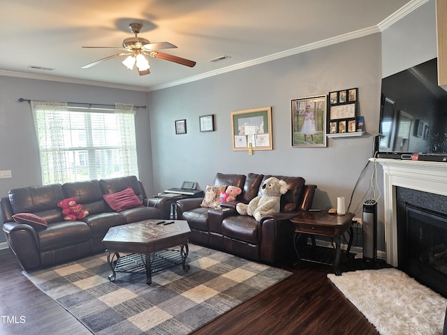 1303 Salters St, Burlington, NC 27215 - living area featuring dark wood-type flooring, ceiling fan, a fireplace, and ornamental molding