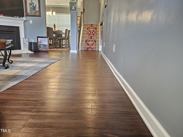 1303 Salters St, Burlington, NC 27215 - hallway with wood finished floors and a chandelier