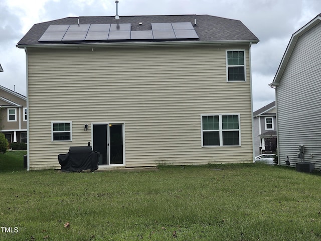 1303 Salters St, Burlington, NC 27215 - rear view of property featuring roof mounted solar panels and a yard