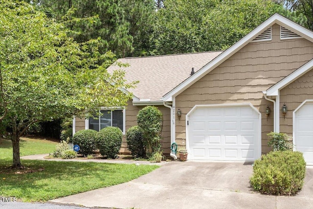 4201 Pin Oak Dr, Durham, NC 27707 - single story home featuring driveway, a garage, a shingled roof, and a front lawn