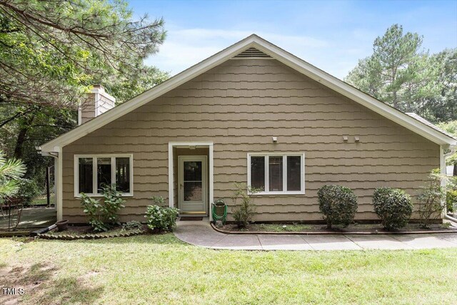 4201 Pin Oak Dr, Durham, NC 27707 - view of front facade with a chimney and a front lawn