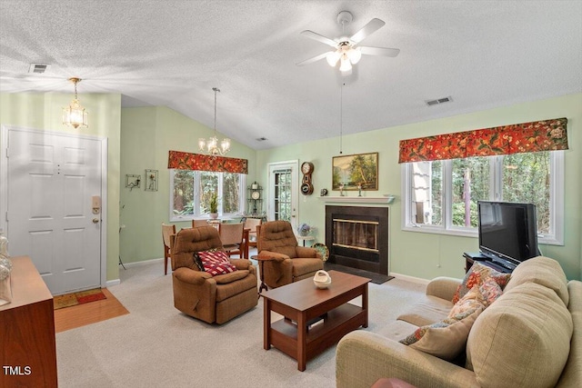 4201 Pin Oak Dr, Durham, NC 27707 - living area with a chandelier, a textured ceiling, healthy amount of natural light, a fireplace with flush hearth, and light carpet
