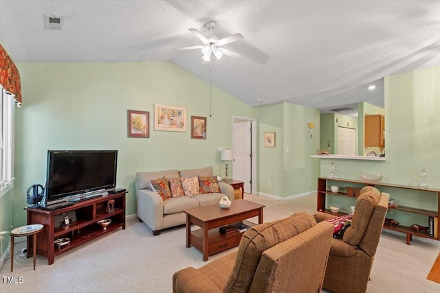 4201 Pin Oak Dr, Durham, NC 27707 - living room featuring a ceiling fan, vaulted ceiling, light colored carpet, and a textured ceiling