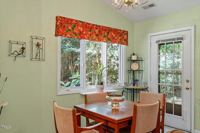 4201 Pin Oak Dr, Durham, NC 27707 - dining area with a chandelier and lofted ceiling