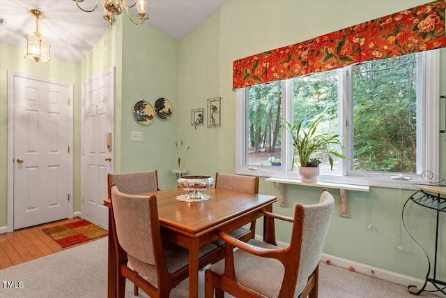 4201 Pin Oak Dr, Durham, NC 27707 - carpeted dining area featuring baseboards and a chandelier