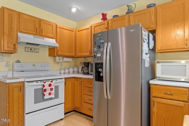 4201 Pin Oak Dr, Durham, NC 27707 - kitchen featuring white appliances, under cabinet range hood, light countertops, and a textured ceiling