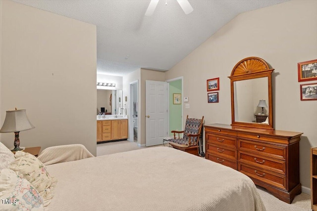 4201 Pin Oak Dr, Durham, NC 27707 - bedroom with vaulted ceiling, light carpet, connected bathroom, ceiling fan, and a textured ceiling