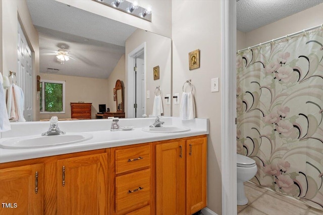 4201 Pin Oak Dr, Durham, NC 27707 - bathroom featuring double vanity, a textured ceiling, ceiling fan, a shower with curtain, and tile patterned floors