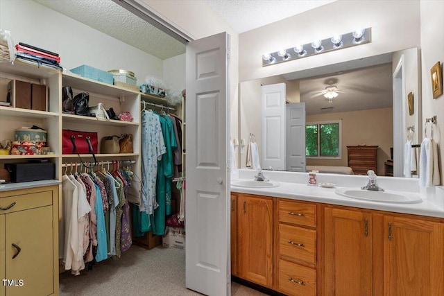 4201 Pin Oak Dr, Durham, NC 27707 - full bath featuring ceiling fan, double vanity, and a textured ceiling