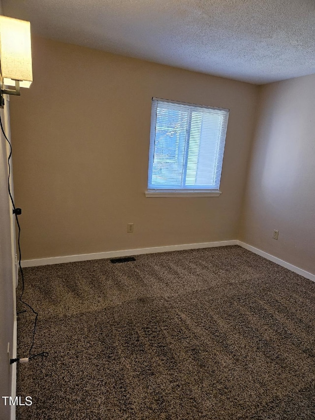 7030 Longstreet Dr Unit A, Raleigh, NC 27615 - carpeted empty room featuring baseboards and a textured ceiling