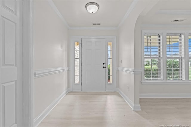 297 Colonist Pl, Cameron, NC 28326 - foyer entrance with light wood-type flooring, arched walkways, and ornamental molding