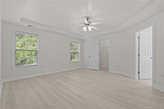 297 Colonist Pl, Cameron, NC 28326 - unfurnished room with a tray ceiling, light wood-type flooring, and a ceiling fan