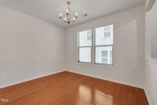 130 Holly Berry Ln, Durham, NC 27703 - unfurnished room featuring a chandelier and wood finished floors