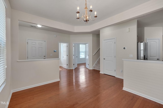 130 Holly Berry Ln, Durham, NC 27703 - spare room featuring stairway, a chandelier, and wood finished floors